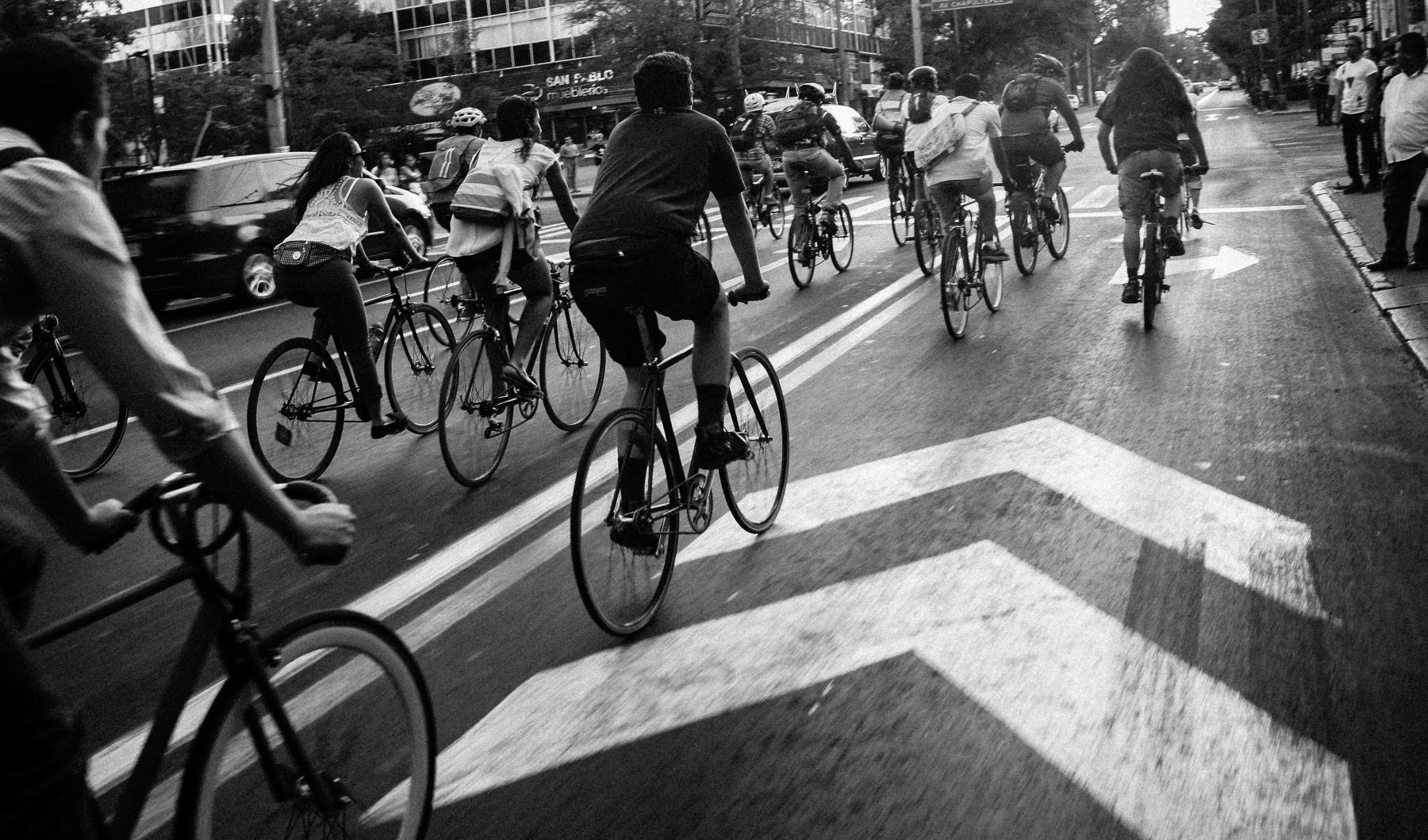 A beautiful community at the heart of all your passions a group of bicyclists riding down a street