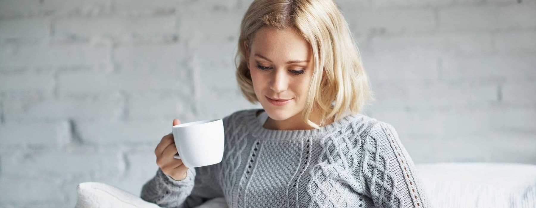 a woman holding a cup of coffee