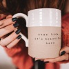 a woman holding a mug