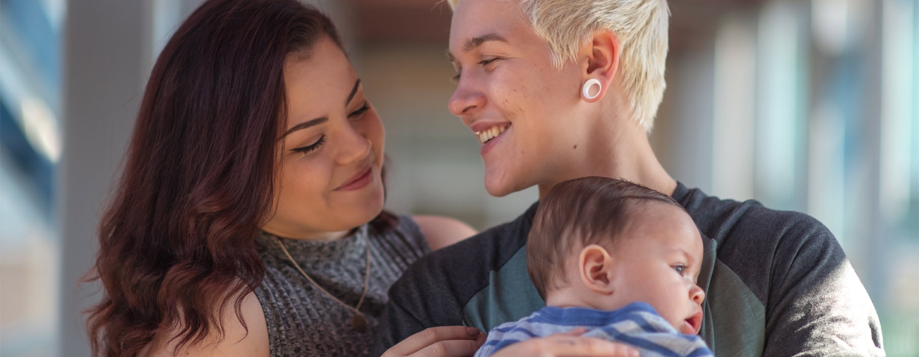 A couple holds their baby