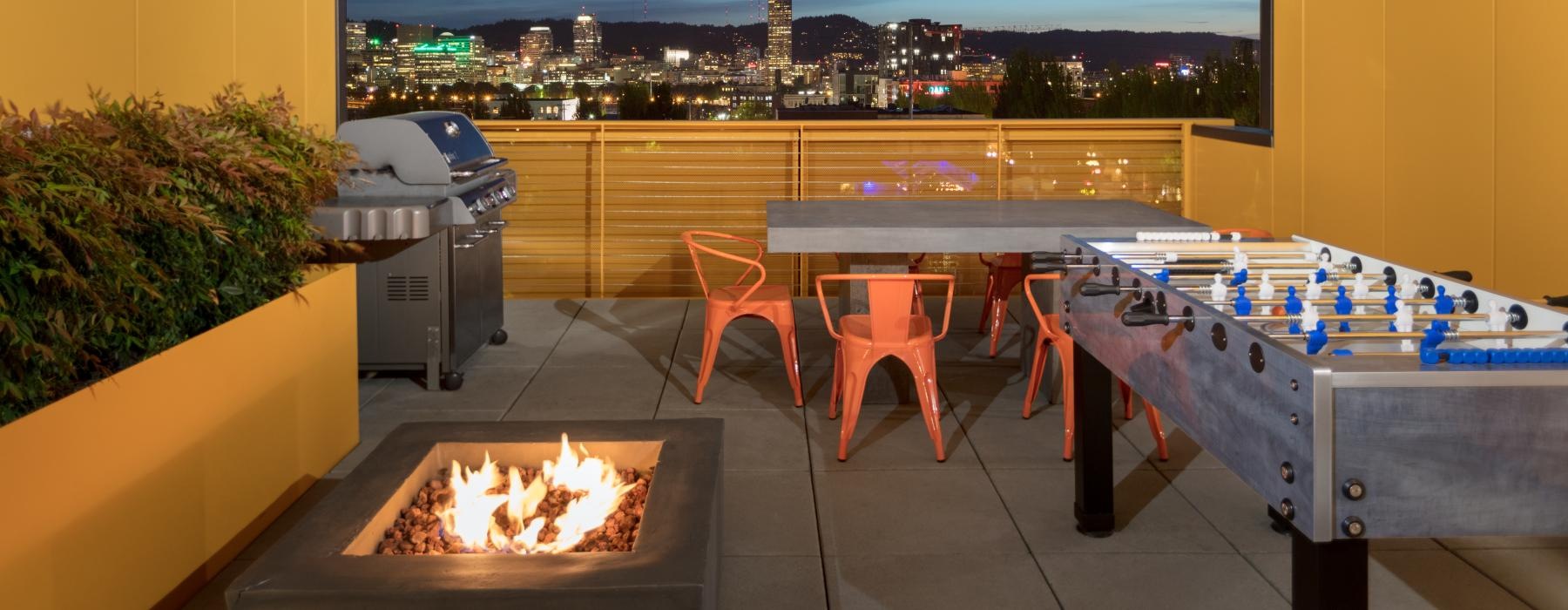a room with a fire pit and a table with a fire pit